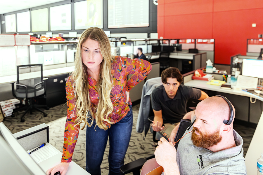 employees at office work station helping to track freight shipments on computer